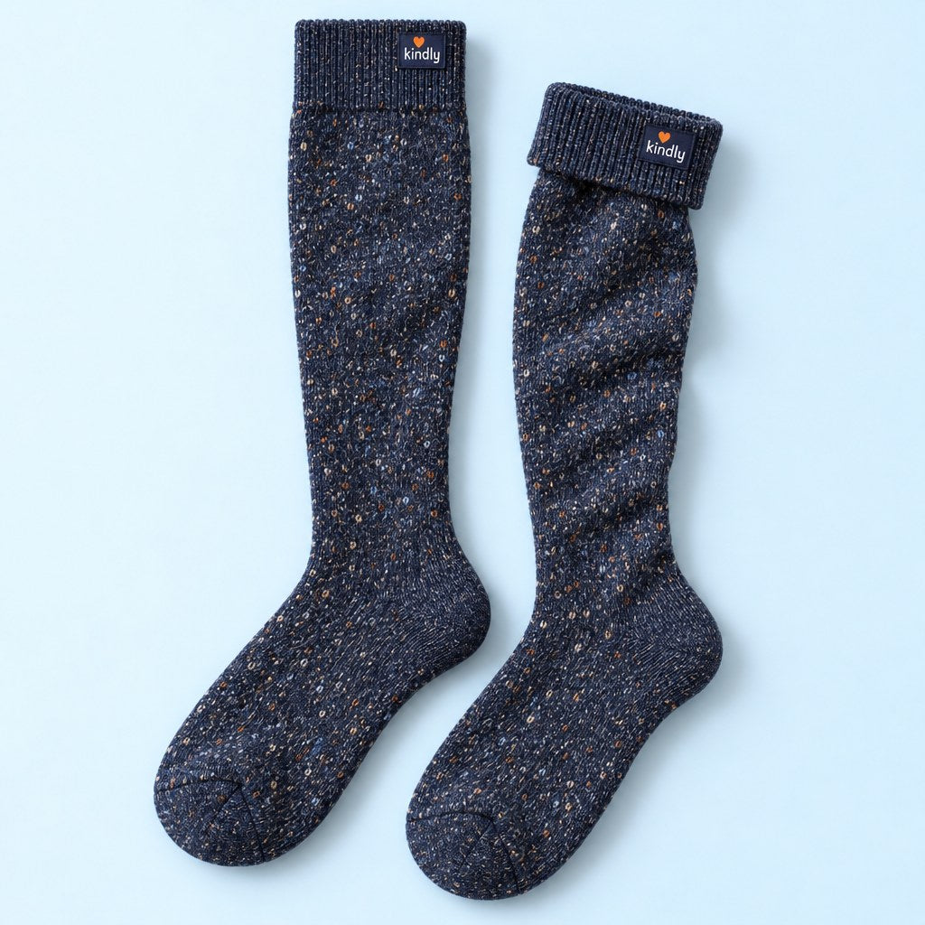Studio flat lay of one pair of Kindly Cabin Socks, thick merino over-the-calf socks in navy heather
