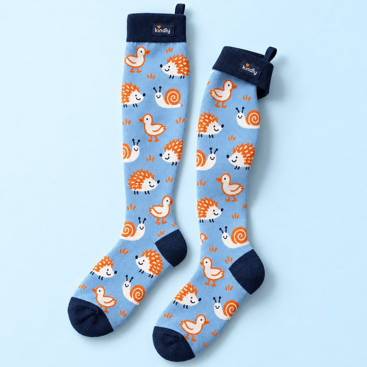 Studio flat lay of one pair of Kindly Doodle Pals knee-high compression socks