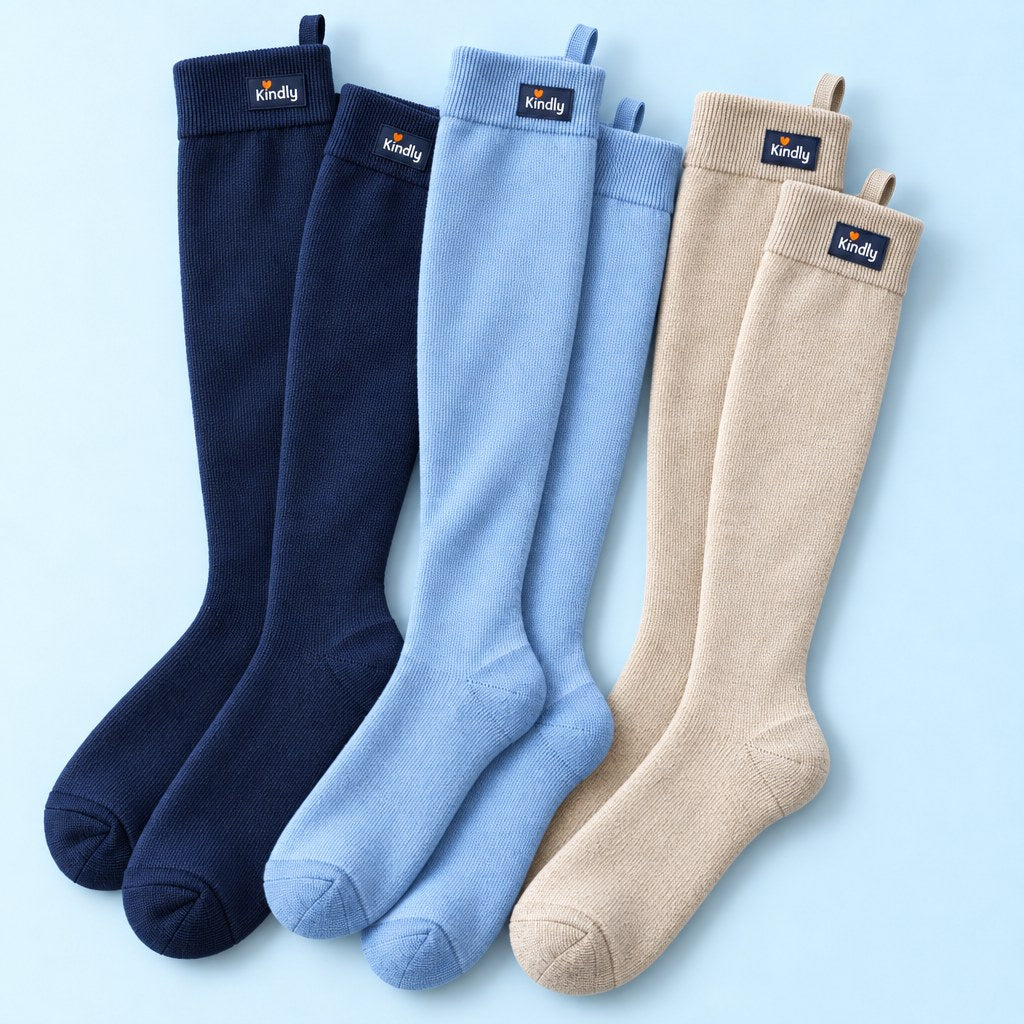 Overhead flat lay of three pairs of Kindly knee-high socks fanned out: the Navy & Neutrals trio