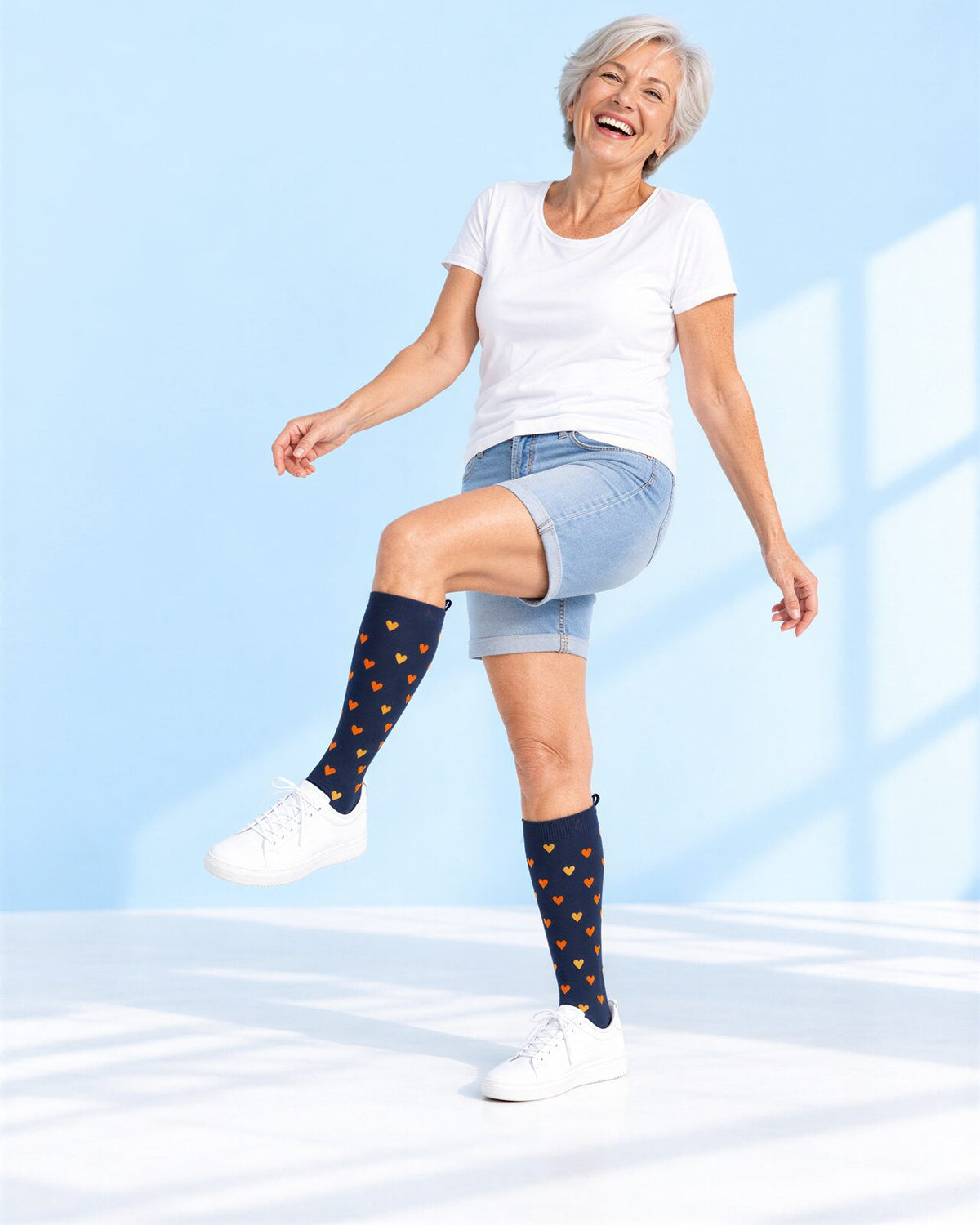 Smiling woman showing her Heart of Gold Kindly compression socks