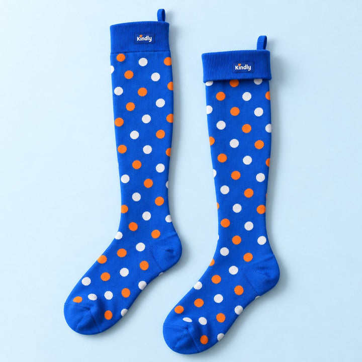 Polka Pop Kindly knee-high compression socks, white and orange dots on electric blue, with the pull loop at the back of the cuff