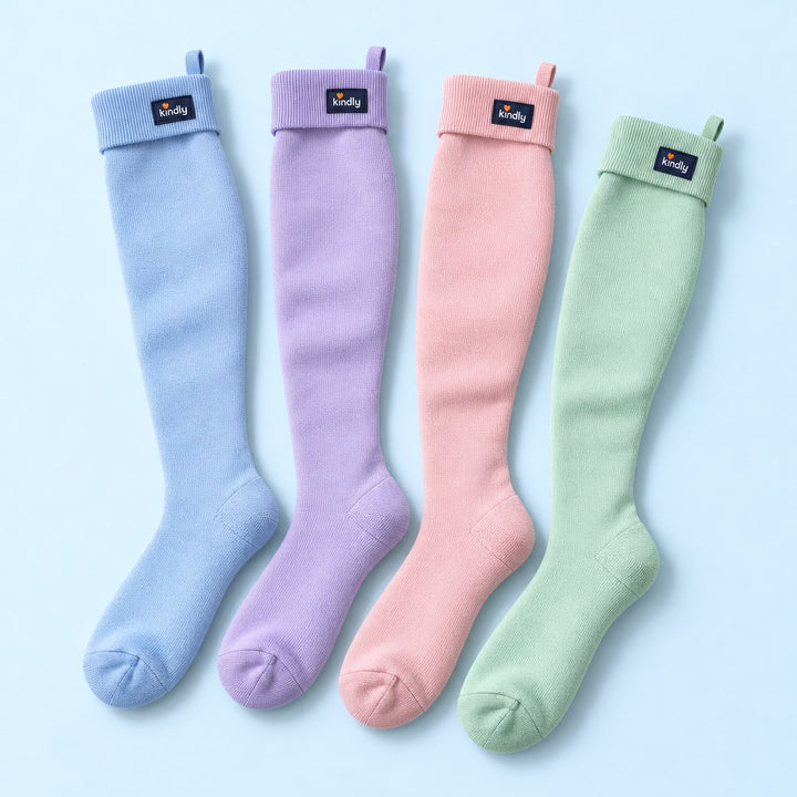 Studio flat lay of four pairs of Kindly Soft Pastels knee-high compression socks side by side