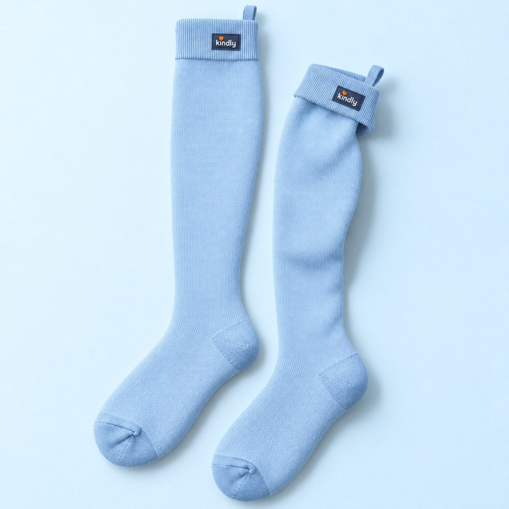 Studio flat lay of one pair of Kindly Soft Pastels knee-high compression socks in Baby Blue